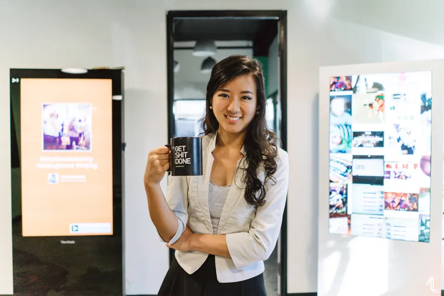 Nanxi Liu holding a mug in her Enplug office