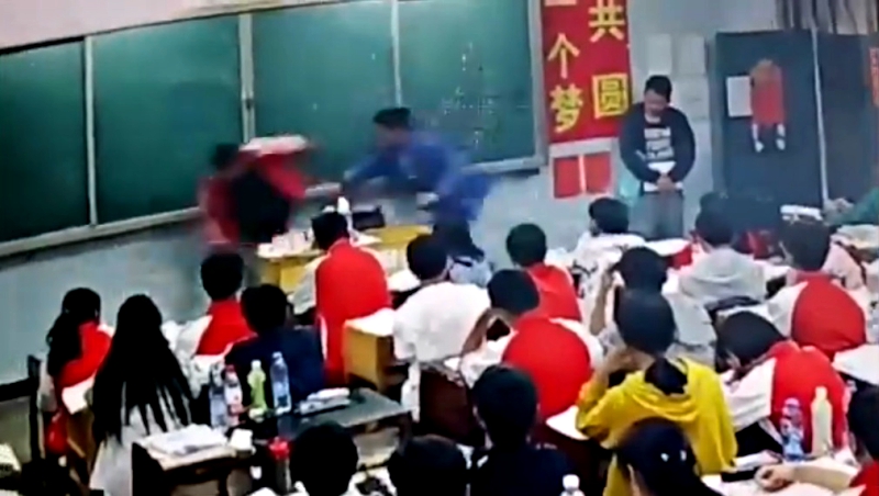 A middle school teacher in southern China has been suspended after assaulting two male students in front of the class.