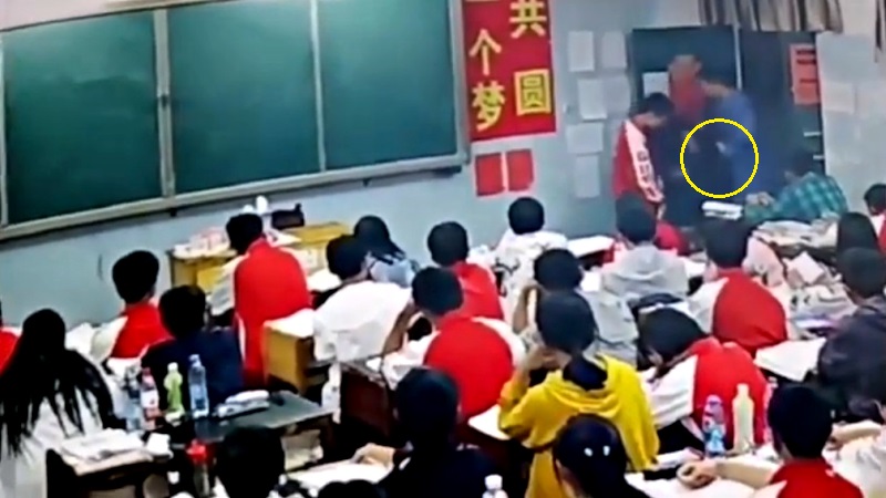 A middle school teacher in southern China has been suspended after assaulting two male students in front of the class.
