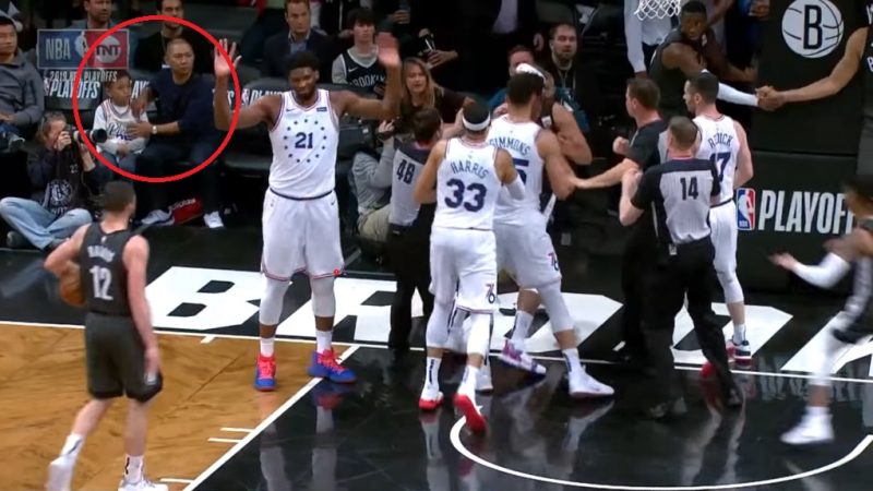 An Asian man who swiftly took his son away from a courtside ruckus is being hailed as “Dad of the Year” on social media.