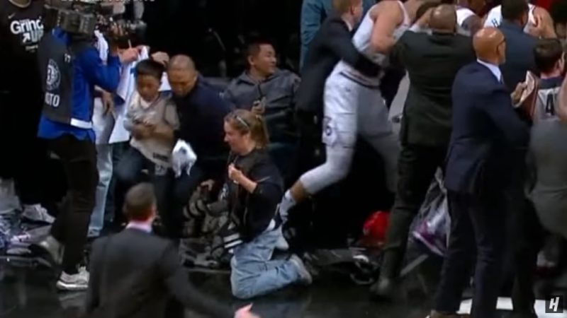 An Asian man who swiftly took his son away from a courtside ruckus is being hailed as “Dad of the Year” on social media.
