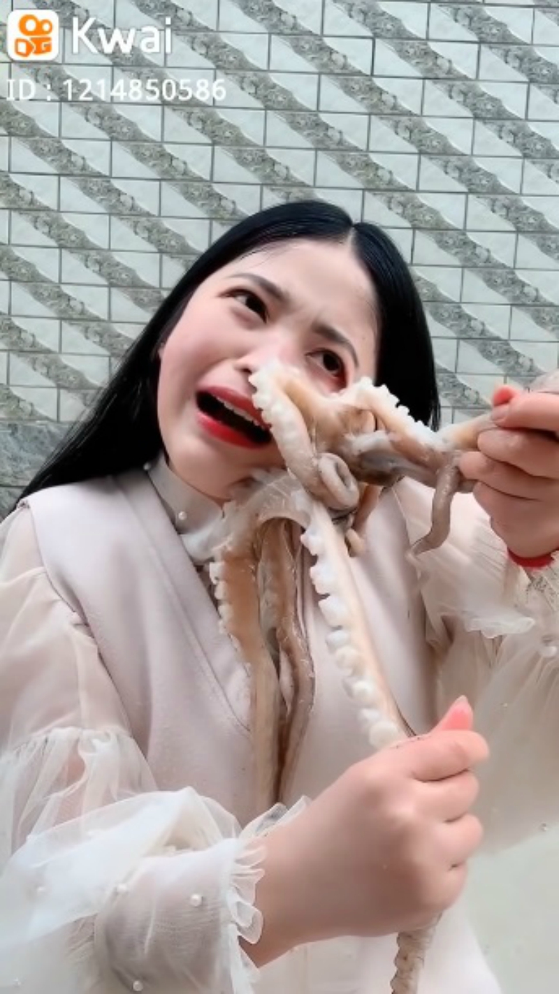 A Chinese livestreamer found her face writhing in pain as an octopus tried to defend itself in her attempts to eat it alive.