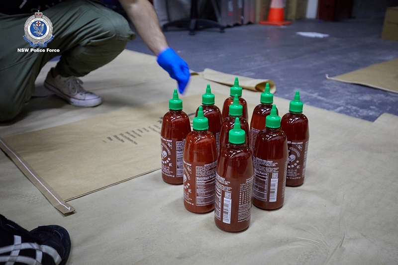 Four Australian men have been arrested for smuggling 400 kilograms (881 pounds) of methylamphetamine inside hundreds of bottles of the popular Asian hot sauce sriracha.