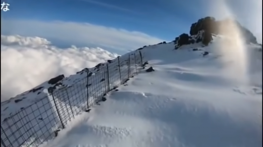 Man climbs mt. fuji in the winter