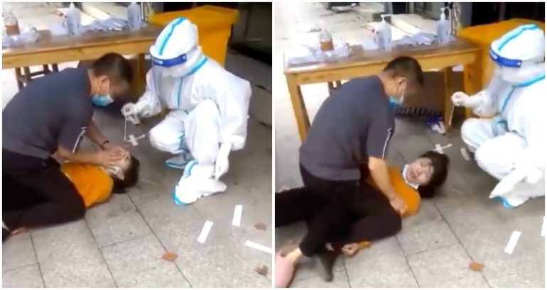 Video: Woman in China forcibly administered COVID test while being pinned down