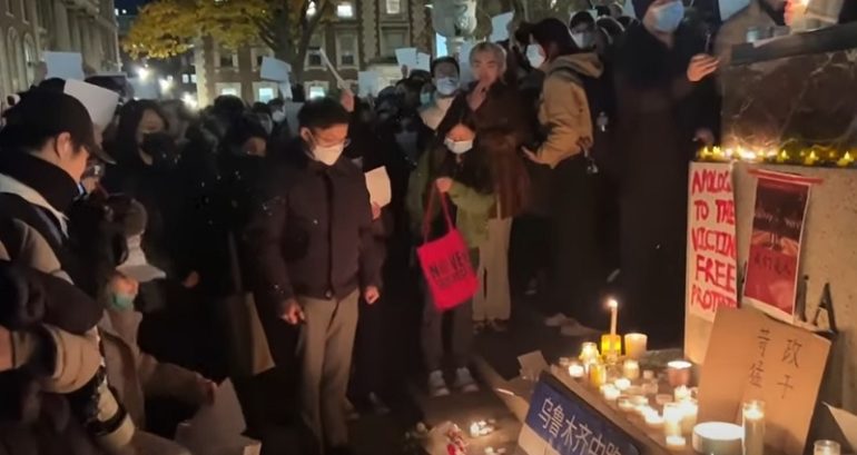Hundreds across US hold up blank sheets of paper while protesting in solidarity with Chinese citizens