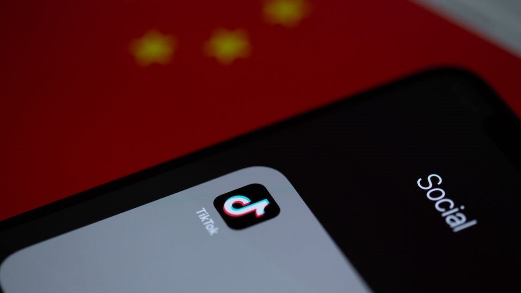 TikTok app on an iPhone with the Chinese flag behind it